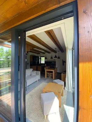 a living room with a sliding glass door leading into a living room at Domki Kuter Port in Gdów
