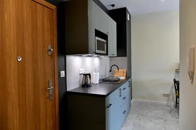 a kitchen with a black counter top and a microwave at Ach To Tu! Apartament Zator in Zator