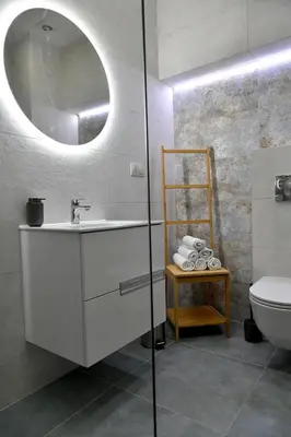a bathroom with a sink and a mirror and a toilet at Ach To Tu! Apartament Zator in Zator