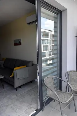 a living room with a couch and chairs and a sliding glass door at Ach To Tu! Apartament Zator in Zator