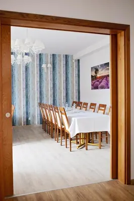 a dining room with a white table and chairs at Janda Resort & Conference in Mszana Dolna