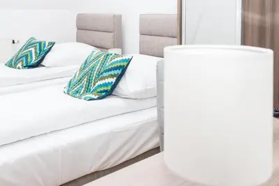 two white beds with pillows in a room at Janda Resort & Conference in Mszana Dolna