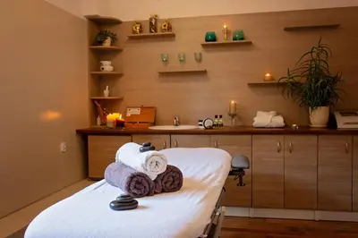 a room with a bed with towels and a sink at Janda Resort & Conference in Mszana Dolna