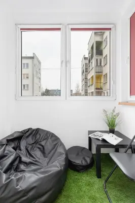 a living room with a bean bag chair and a table at Retro Family Apartment Mały Płaszów by Noclegi Renters in Kraków