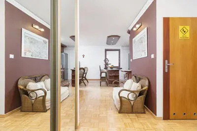 a hallway with chairs and a dining room at Retro Family Apartment Mały Płaszów by Noclegi Renters in Kraków