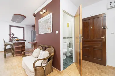 a room with a bathroom with a toilet and a sink at Retro Family Apartment Mały Płaszów by Noclegi Renters in Kraków