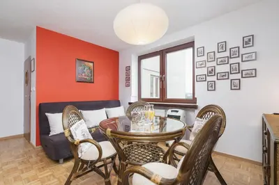 a living room with a table and chairs and a couch at Retro Family Apartment Mały Płaszów by Noclegi Renters in Kraków