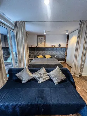 a bedroom with two beds and a large window at By The River in Kraków