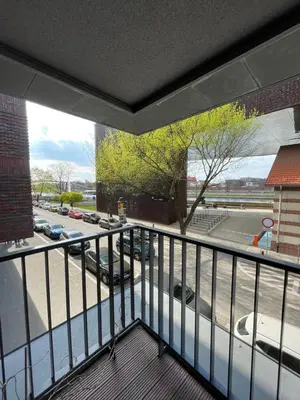 a balcony with a view of a parking lot at By The River in Kraków