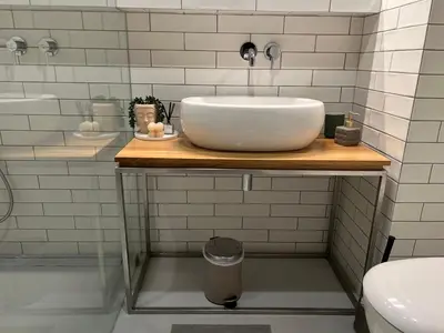 a bathroom with a sink on a wooden counter at By The River in Kraków