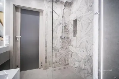 a bathroom with a shower with a mural of flowers at Apartament Best Rest in Wadowice
