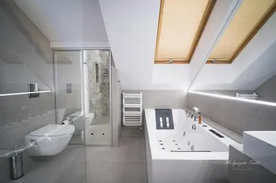 a bathroom with a shower and a toilet and a sink at Apartament Best Rest in Wadowice