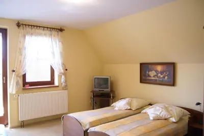 a bedroom with two beds and a television at Agro-Gala in Rabka