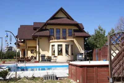 a house with a swimming pool in front of it at Agro-Gala in Rabka