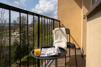 a table with a plate of food and a glass of orange juice at Staymoovers - Ladne mieszkanie w poblizu Energylandii - Parking in Zator