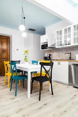 a kitchen with a white table and chairs at Magnificent Apartments Zyblikiewicza 11a, central location in Kraków