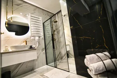 a bathroom with a shower and a sink at ApartPark Centrum Zator in Zator