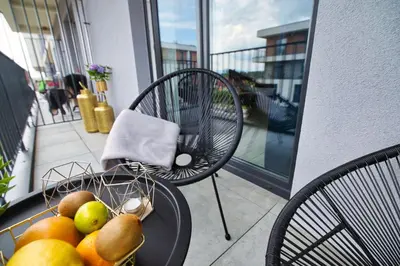 a bowl of fruit on a table on a balcony at ApartPark Centrum Zator in Zator