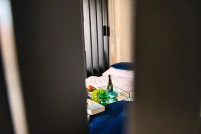 a room with a bed and a table with a bottle of wine at ApartPark Centrum Zator in Zator