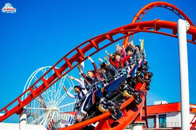 a group of people riding on a roller coaster at ApartPark Centrum Zator in Zator