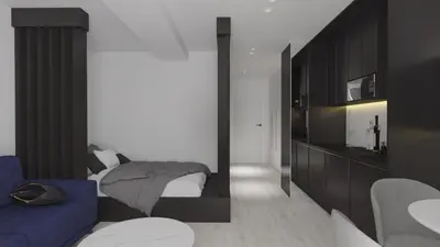 a bedroom with a bed and a blue couch at ApartPark Centrum Zator in Zator