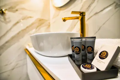 a bathroom counter with a sink and some products on it at ApartPark Centrum Zator in Zator