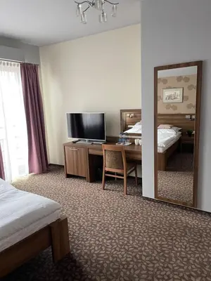 a large bed in a bedroom with red walls at Apartamenty Centrum in Olkusz