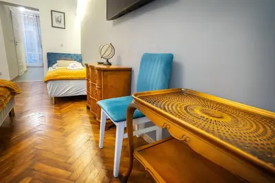 a room with a bed and a table and chairs at KrakowApart Zyblikiewicza in Kraków
