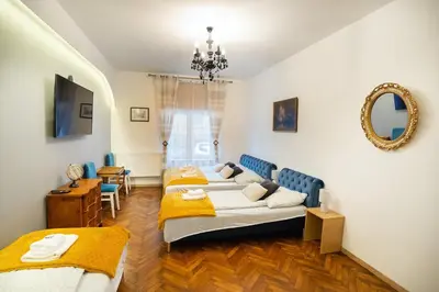 a bedroom with two beds and a mirror at KrakowApart Zyblikiewicza in Kraków