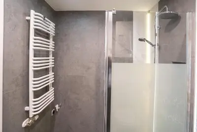 a bathroom with a shower with a glass door at KrakowApart Zyblikiewicza in Kraków