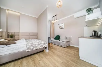 a bedroom with a bed and a couch at Apartament A Dietla in Kraków