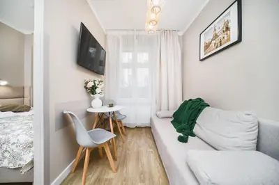 a living room with a couch and a table at Apartament A Dietla in Kraków