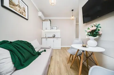 a living room with a couch and a table at Apartament A Dietla in Kraków