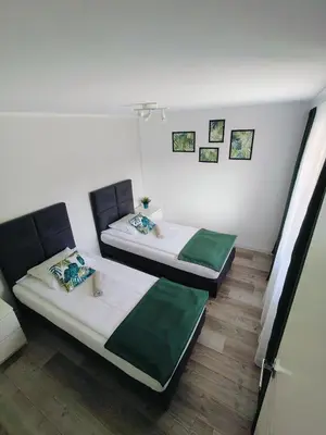 two twin beds in a room with at Apartament Sumik in Zator