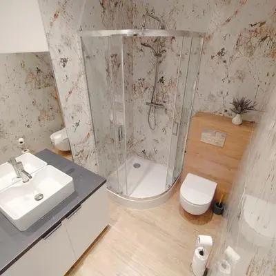 a bathroom with a shower and a toilet and a sink at Apartament Sumik in Zator