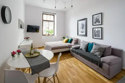 a living room with a couch and a table at Discover Krakow Apartments - 5 Borowickiej St - Studio next to Opera and Unity Centre in Kraków