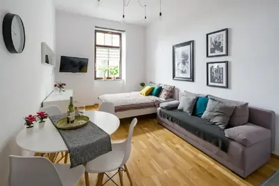 a living room with a couch and a table at Discover Krakow Apartments - 5 Borowickiej St - Studio next to Opera and Unity Centre in Kraków