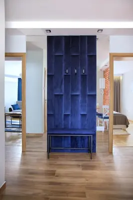 a living room with a blue wall and a couch at Apart-Wita in Wadowice