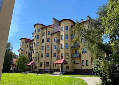 a large yellow building with red roof at Apart-Wita in Wadowice