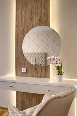 a dressing table with a mirror on a wall at Apart-Wita in Wadowice