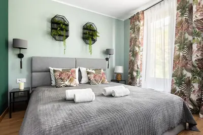 a bedroom with a bed with two towels on it at Mary&Arte Apartments Grzegórzecka 15 in Kraków