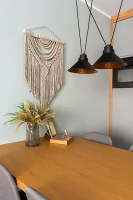 a dining room table with a plant and two lights at Mary&Arte Apartments Grzegórzecka 15 in Kraków