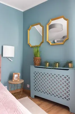 a bedroom with blue walls and a dresser with a mirror at Mary&Arte Apartments Grzegórzecka 15 in Kraków