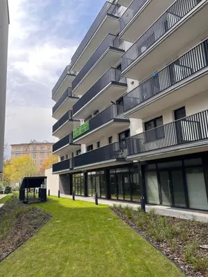 a large building with a lawn in front of it at Mary&Arte Apartments Grzegórzecka 15 in Kraków