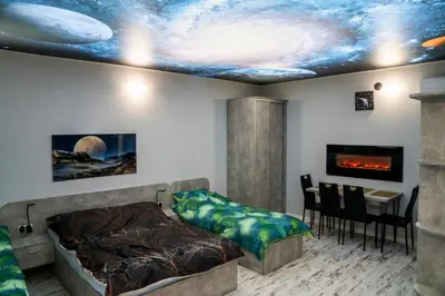 a bedroom with a bed and a dining room with a table at Willa Pod Zamczyskiem in Podzamcze