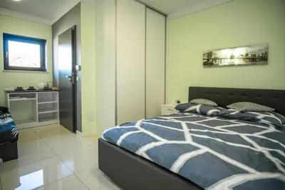 a bedroom with a bed with a blue and white comforter at Willa Pod Zamczyskiem in Podzamcze