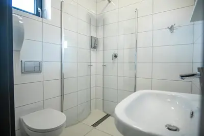a bathroom with a shower and a toilet and a sink at Willa Pod Zamczyskiem in Podzamcze