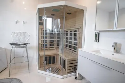 a glass shower in a bathroom with a sink at Willa Pod Zamczyskiem in Podzamcze