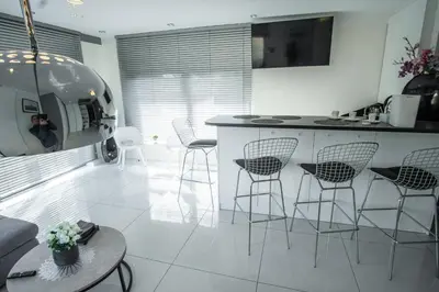 a kitchen with chairs and a counter in a room at Willa Pod Zamczyskiem in Podzamcze