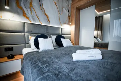 a bedroom with a large bed with two pillows on it at Boutique 62 by Housine in Zator